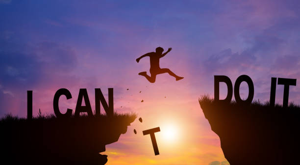 Person jumping across a gap between cliffs with the words "I Can Do It," symbolizing the motivation and purpose needed for recovery and long-term sobriety.