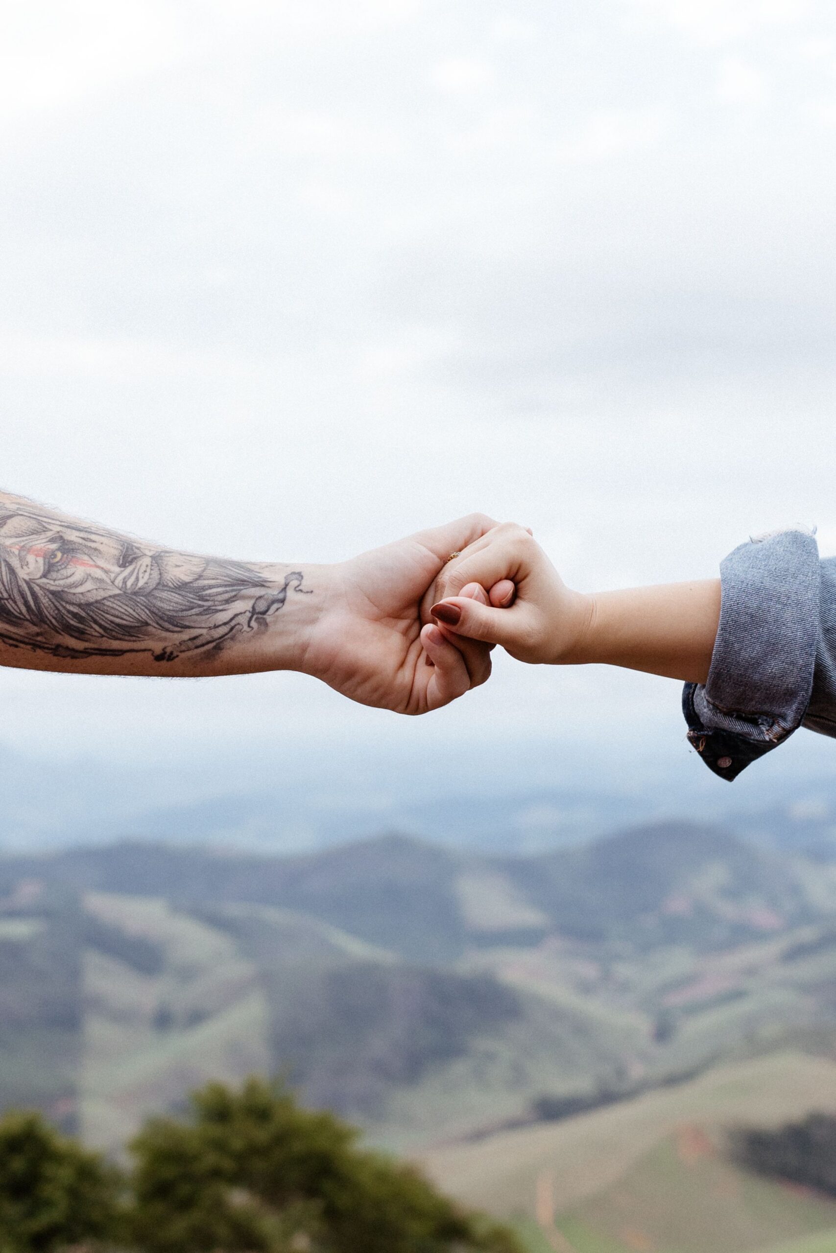 One person holding another person’s hand as a gesture of support